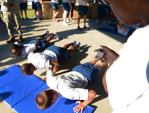 U.S. Air Force Staff Sgt. Nikita Toon, 20th Communications Squadron NCO in charge of knowledge operations, keeps track of the total pushups of each team participating in the 20th Mission Support Group Warrior Challenge, Shaw Air Force Base, S.C., Sept. 6, 2013. The 20th MSG Warrior Challenge was held to boost the morale and camaraderie of the Airmen and Soldiers who participated. (U.S. Air Force photo by Senior Airman Tabatha Zarrella/Released)