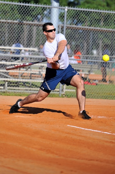 A U.S. Air Force Airman swings at a softball during the 20th Mission Support Group Warrior Challenge, Shaw Air Force Base, S.C., Sept. 6, 2013.  The 20th MSG Warrior Challenge, a daylong event meant to boost morale between Airmen and Soldiers, included softball, tug of war,  watermelon eating contest and other events to build camaraderie.  (U.S. Air Force photo by Airman 1st Class Jensen Stidham/Released)