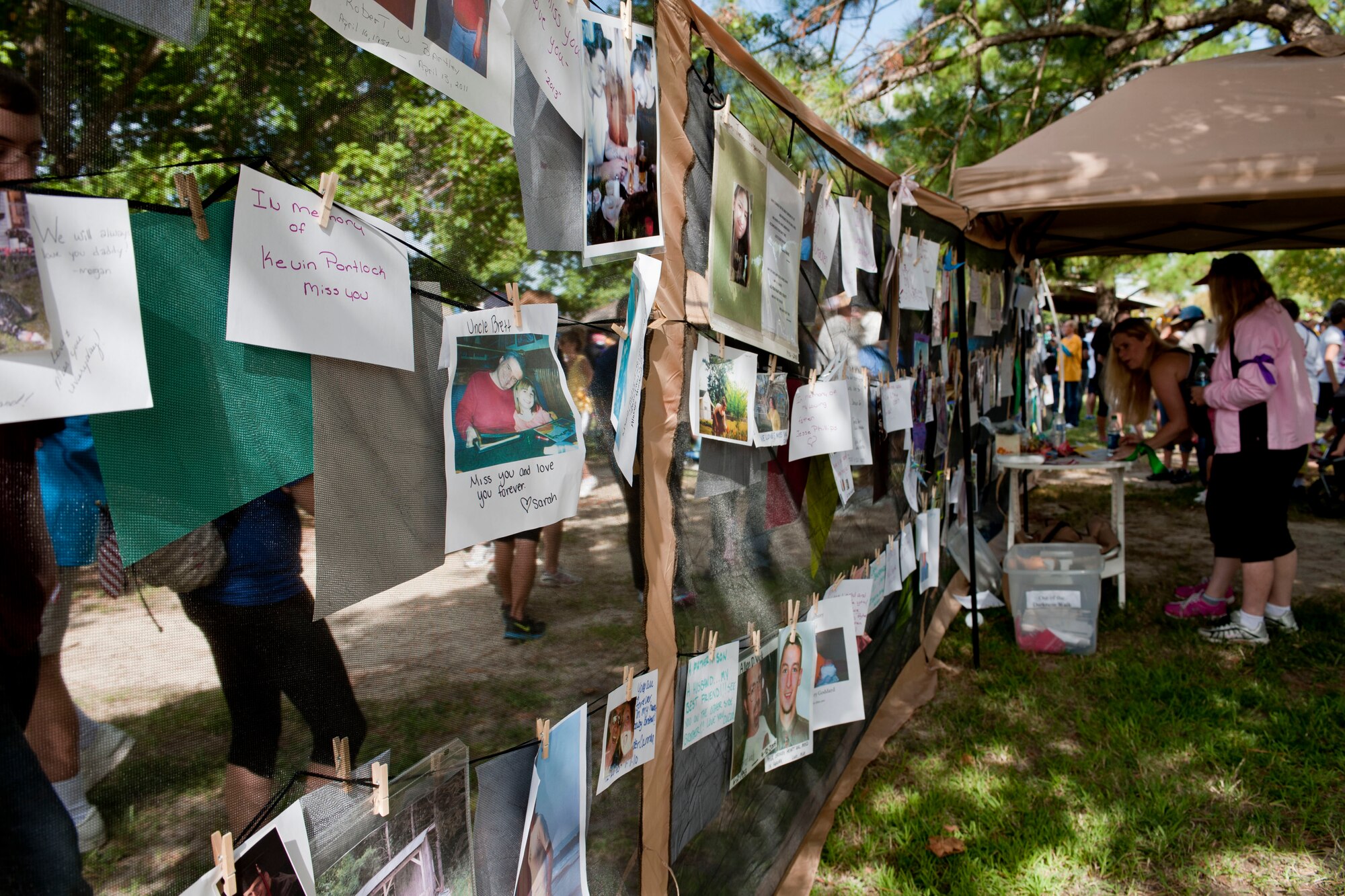 A wall of photos of suicide victims is used as a remembrance wall during the Out of Darkness suicide awareness walk in Virginia Beach, Va., Sept. 7, 2013. The wall was used to remember and celebrate the lives of participants’ loved ones. (U.S. Air Force photo by Staff Sgt. Stephanie Rubi/Released)