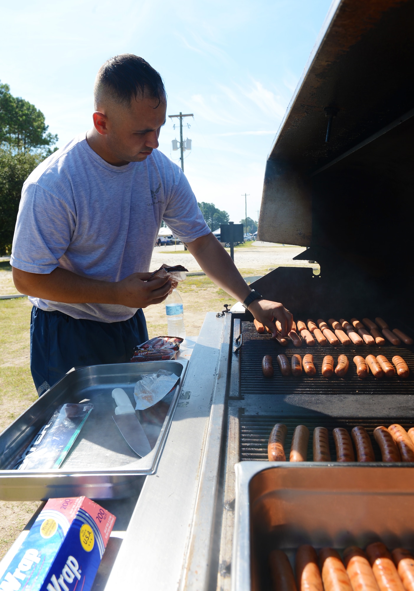 U.S. Air Force Senior Airman Jeremy Charusch, 20th Force Support Squadron fitness specialist, grills hot dogs for Airmen and Soldiers who participated in the 20th Mission Support Group Warrior Challenge at Shaw Air Force Base, S.C., Sept. 6, 2013. The 20th MSG Warrior Challenge was held to boost the morale and camaraderie of the Airmen and Soldiers who participated. (U.S. Air Force photo by Senior Airman Tabatha Zarrella/Released)
