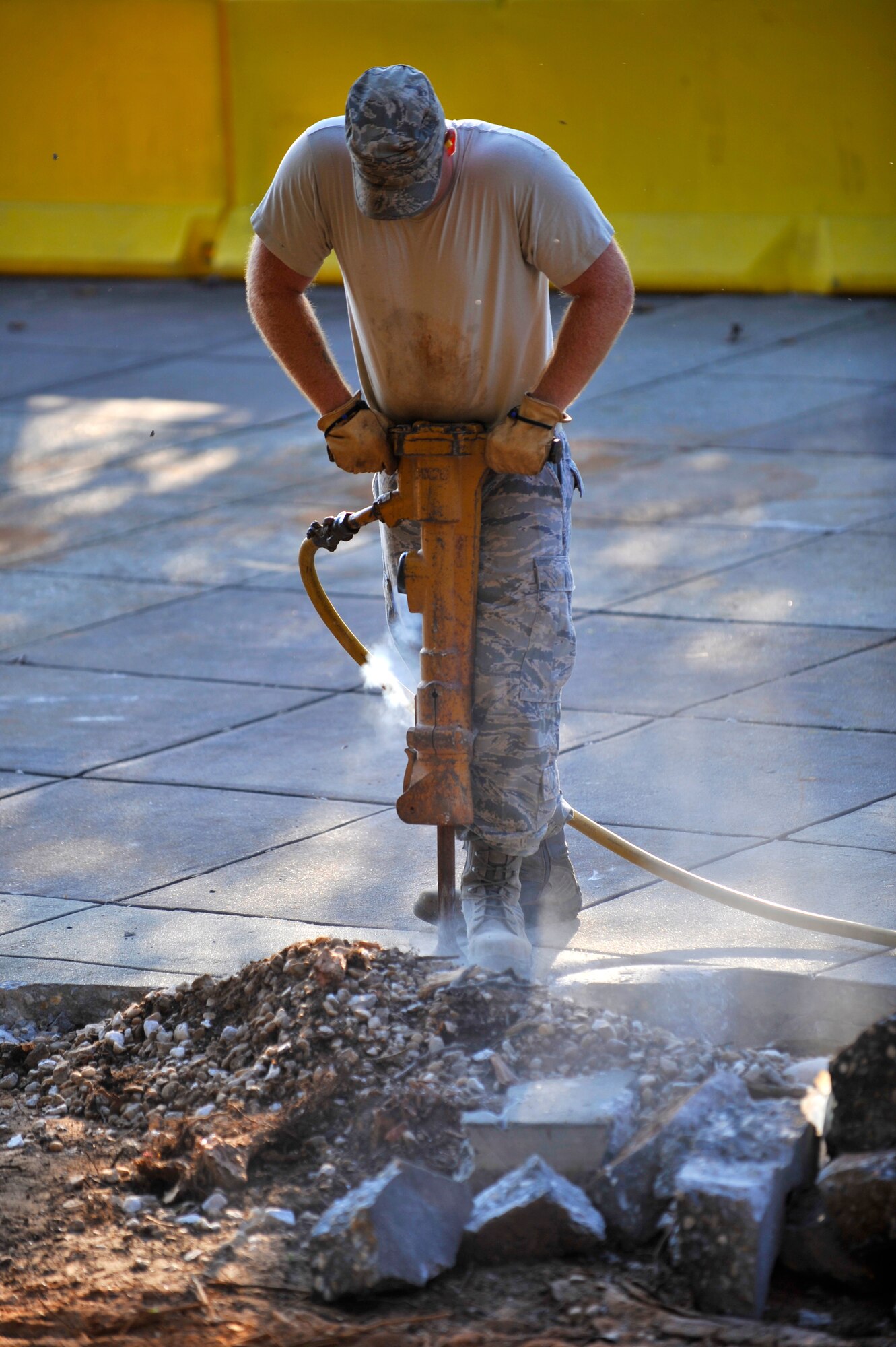 U.S. Air Force Staff Sgt. Sonny Tanner, 20th Civil Engineer Squadron, jackhammers pavement during construction Shaw Air Force Base, S.C., Sept 3, 2013. Construction started at the 20th Force Support Squadron building to avoid tripping hazards for patrons and employees entering the facility. (U.S. Air Force photo by Airman 1st Class Jensen Stidham/Released)