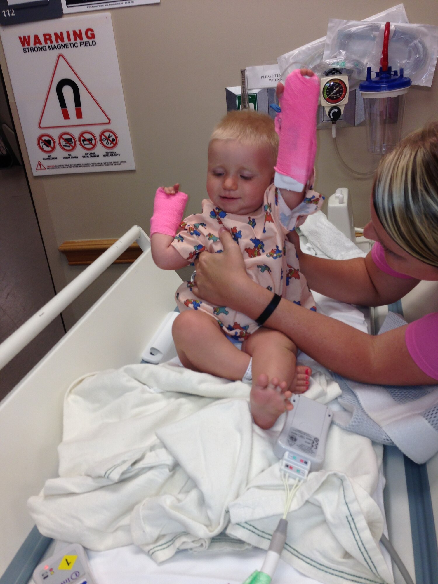 Haleigh Wilhide, spouse of Tech. Sgt. Randy Wilhide, 4th Equipment Maintenance Squadron assistant NCO in-charge of precision-guided munitions, cares for their daughter Piper, 1 year old, at a hospital in Greenville, N.C., July 10, 2013. Piper underwent more than five rounds of chemotherapy and a surgery during her nearly seven-month battle with cancer. (Courtesy photo)