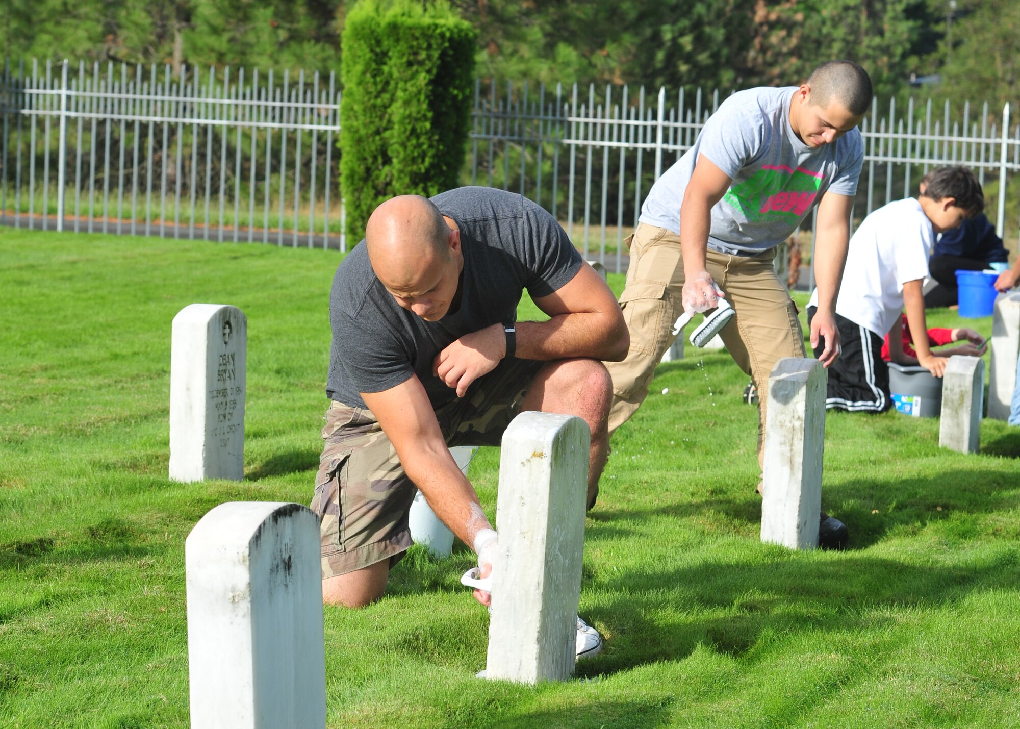 Members of Team Fairchild clean grave stones at Fort George Wright cemetery at Spokane, Wash., Sept. 7, 2013. The Airmen also removed dead branches, brush and cleaned up all debris around the cemetery. (U.S. Air Force photo by Senior Airman Taylor Curry/Released)