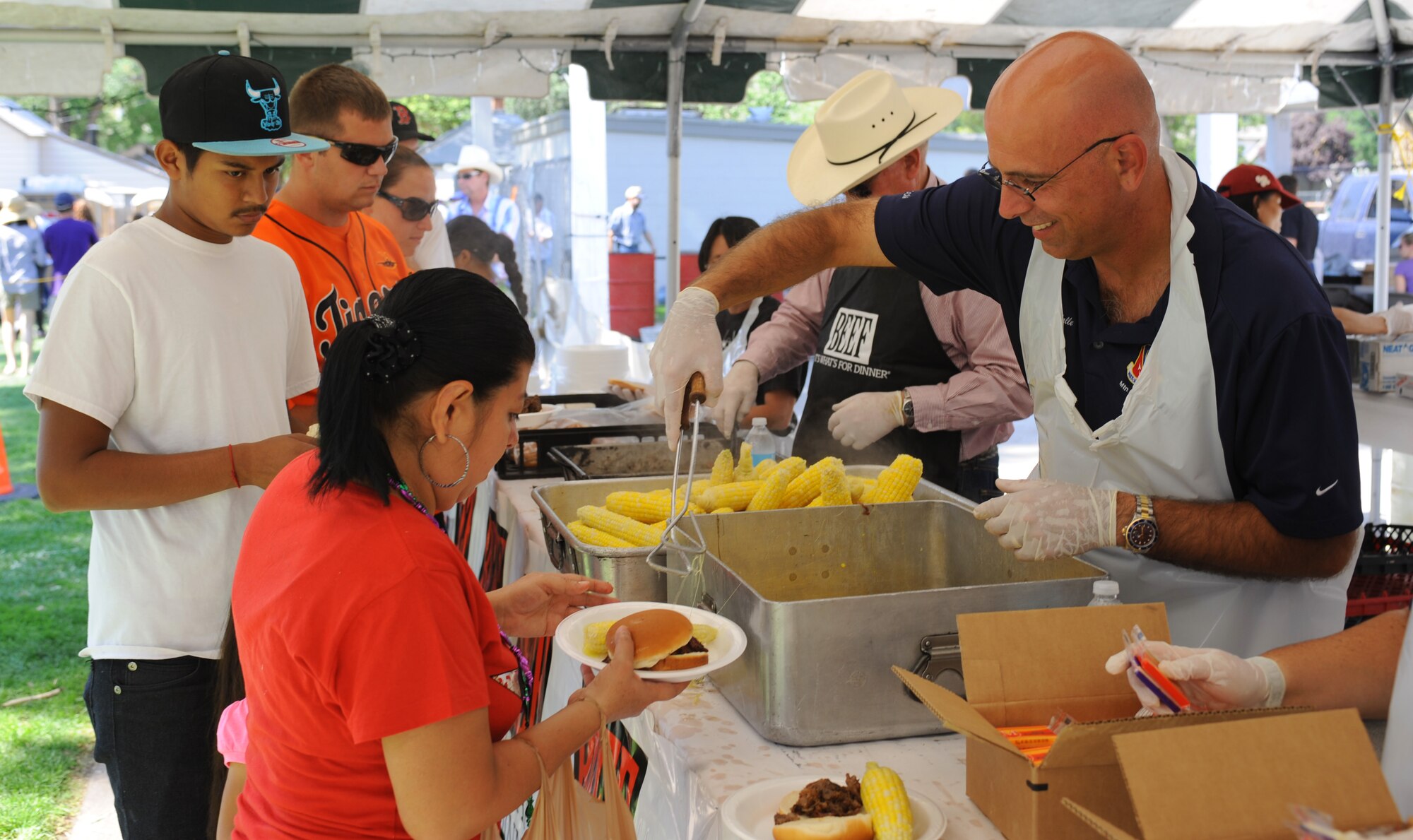 U.S. Air Force Chief Master Sgt. Alex del Valle, 366th Fighter Wing command chief, serves corn Sept. 7, 2013, during Air Force Appreciation Days in Mountain Home, Idaho. Base and local community members came together to celebrate their unique relationship with food, fun and games during the day-long event. (U.S. Air Force photo by Senior Airman Benjamin Sutton/Released)