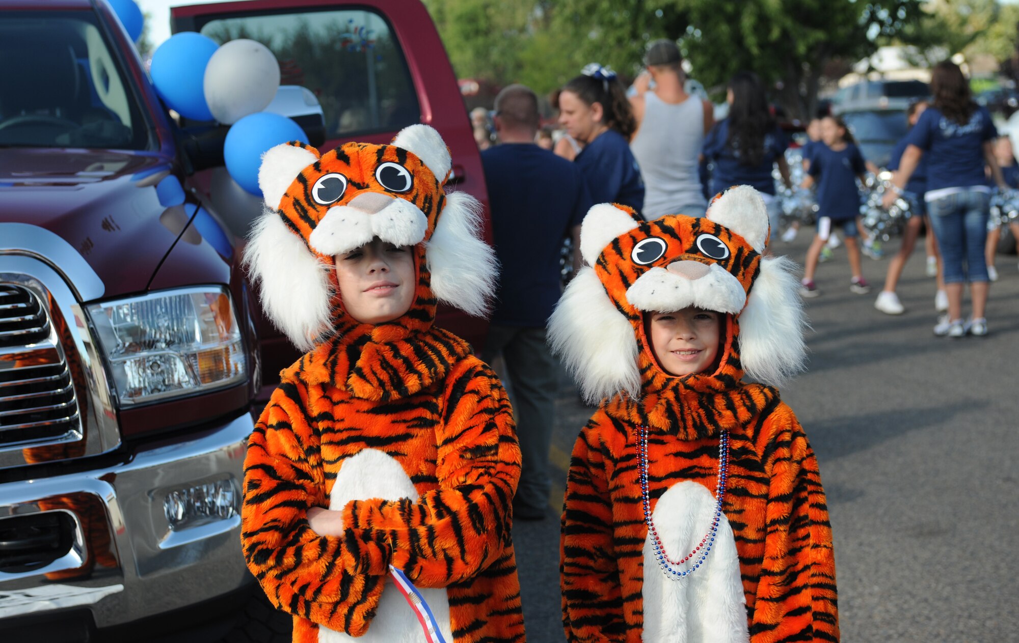 Two children pose before the start of the Air Force Appreciation Days parade Sept. 7, 2013, in Mountain Home, Idaho. Members of the 366th Fighter Wing and other area residents came together to celebrate the partnership between the base and local community. (U.S. Air Force photo by Senior Airman Benjamin Sutton/Released)