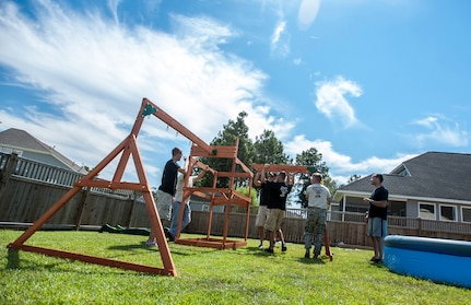 Airmen from the 628th Security Forces Squadron military working dog handlers build a swing set for a deployed Wingman’s daughter. Staff Sgt. Kyle Shaughnessy, 628th SFS MWD handler, is currently deployed to Southwest Asia. His fellow Airmen built the swing set in accordance with the Trident United Way’s Day of Caring events occurring throughout Joint Base Charleston, where approximately 2,500 service members volunteered their skills to assist with more than 50 projects in the local community. The base held their volunteer events a week earlier than Trident the Day of Caring, due to operational commitments including the delivery of the final U.S. Air Force C-17 Globemaster III.
 (U.S. Air Force Photo / Senior Airman Tom Brading)
