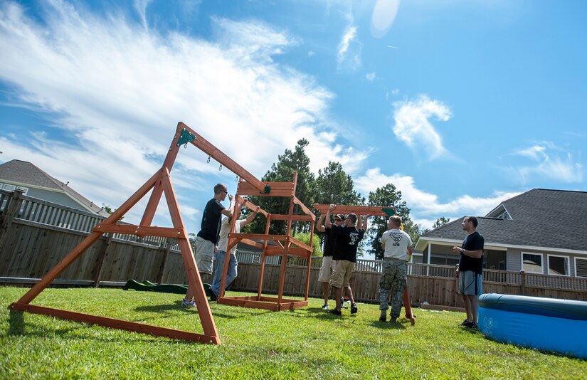 Airmen from the 628th Security Forces Squadron military working dog handlers build a swing set for a deployed Wingman’s daughter. Staff Sgt. Kyle Shaughnessy, 628th SFS MWD handler, is currently deployed to Southwest Asia. His fellow Airmen built the swing set in accordance with the Trident United Way’s Day of Caring events occurring throughout Joint Base Charleston, where approximately 2,500 service members volunteered their skills to assist with more than 50 projects in the local community. The base held their volunteer events a week earlier than Trident the Day of Caring, due to operational commitments including the delivery of the final U.S. Air Force C-17 Globemaster III.
 (U.S. Air Force Photo / Senior Airman Tom Brading)

