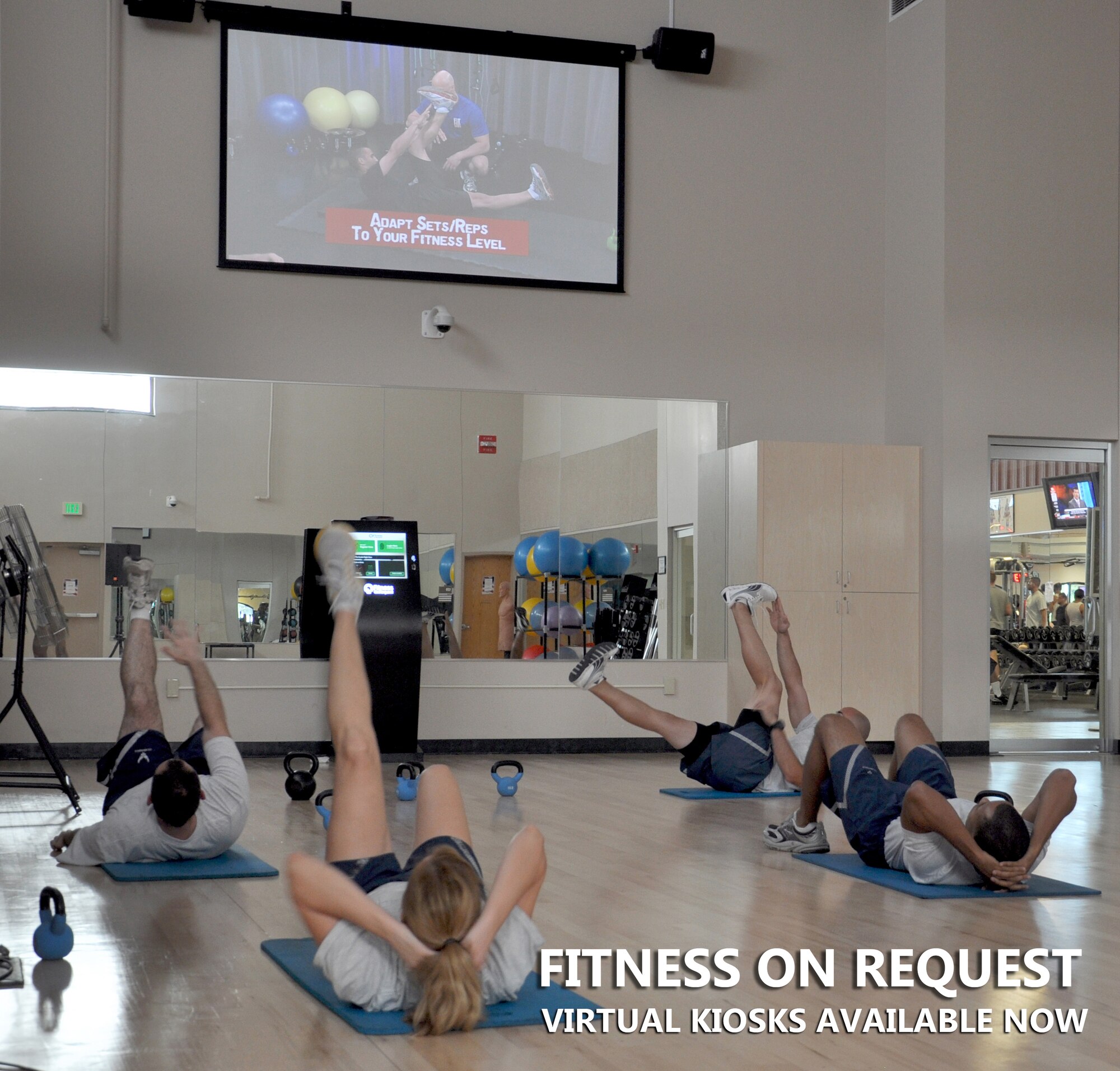 Airmen and family members use the “Fitness on Request” kiosk at the Rambler Fitness Center on Joint Base San Antonio – Randolph, Texas, Aug. 14, 2013. The Air Force is installing kiosks at 66 locations by the end of September which are available to all Airmen, including retirees and family members, at base fitness and sports centers. Workout routines include kinetics, technical knockout kickboxing, step aerobics, cycling and fusion, which run for 20-, 30-, 45- and 60-minute increments. (U.S. Air Force photo by Staff Sgt. Ian Hoachlander/Released)