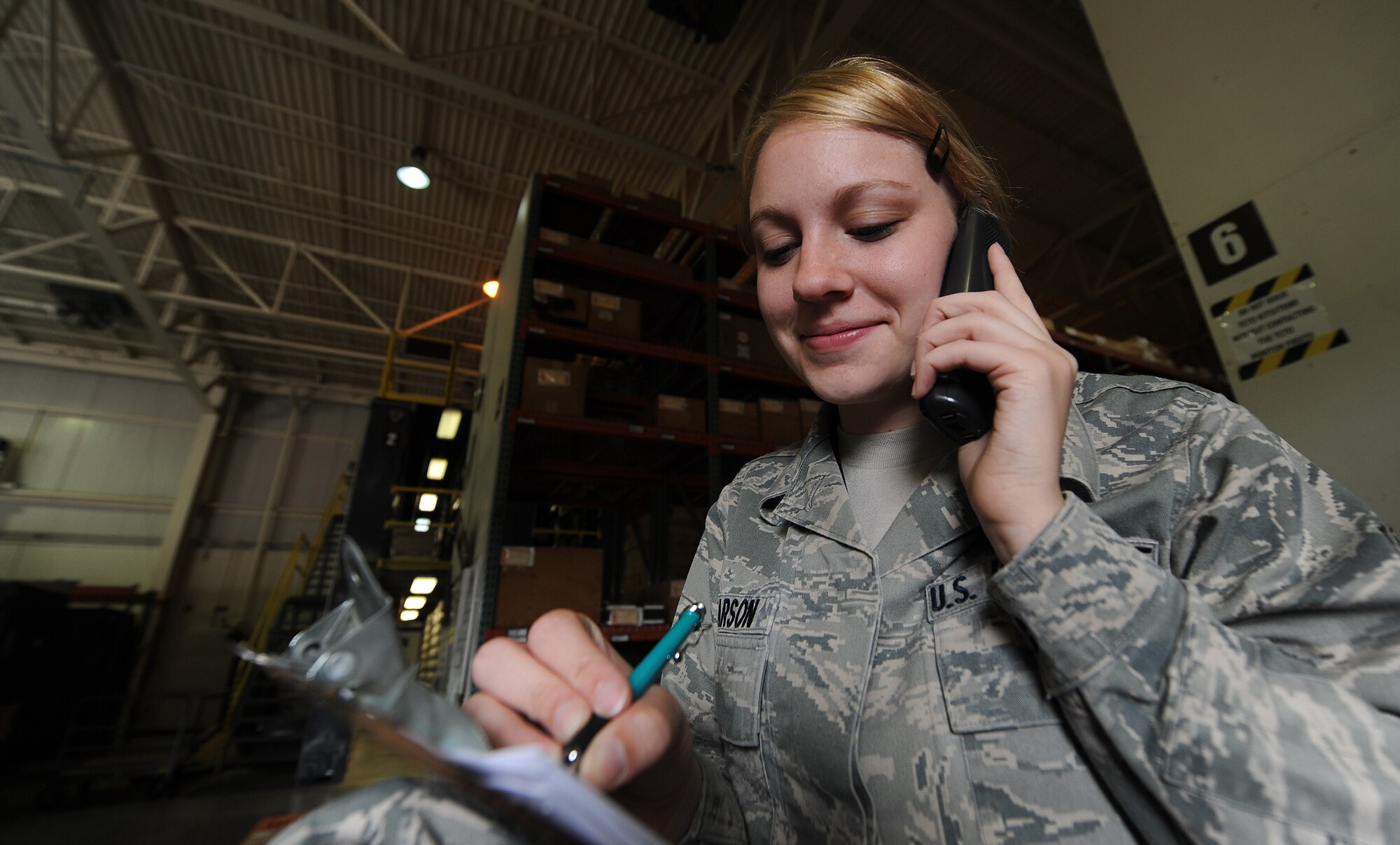 U.S. Air Force Senior Airman Sarah Pearson, 509th Logistics Readiness Squadron aircraft parts journeyman, interfaces with maintainers to order a part in the aircraft part store at Whiteman Air Force Base, Mo., Aug. 2, 2013. Part of her interfacing process includes annotating tail numbers of aircraft and other information pertinent to the order. (U.S. Air Force photo by Staff Sgt. Nick Wilson/Released)