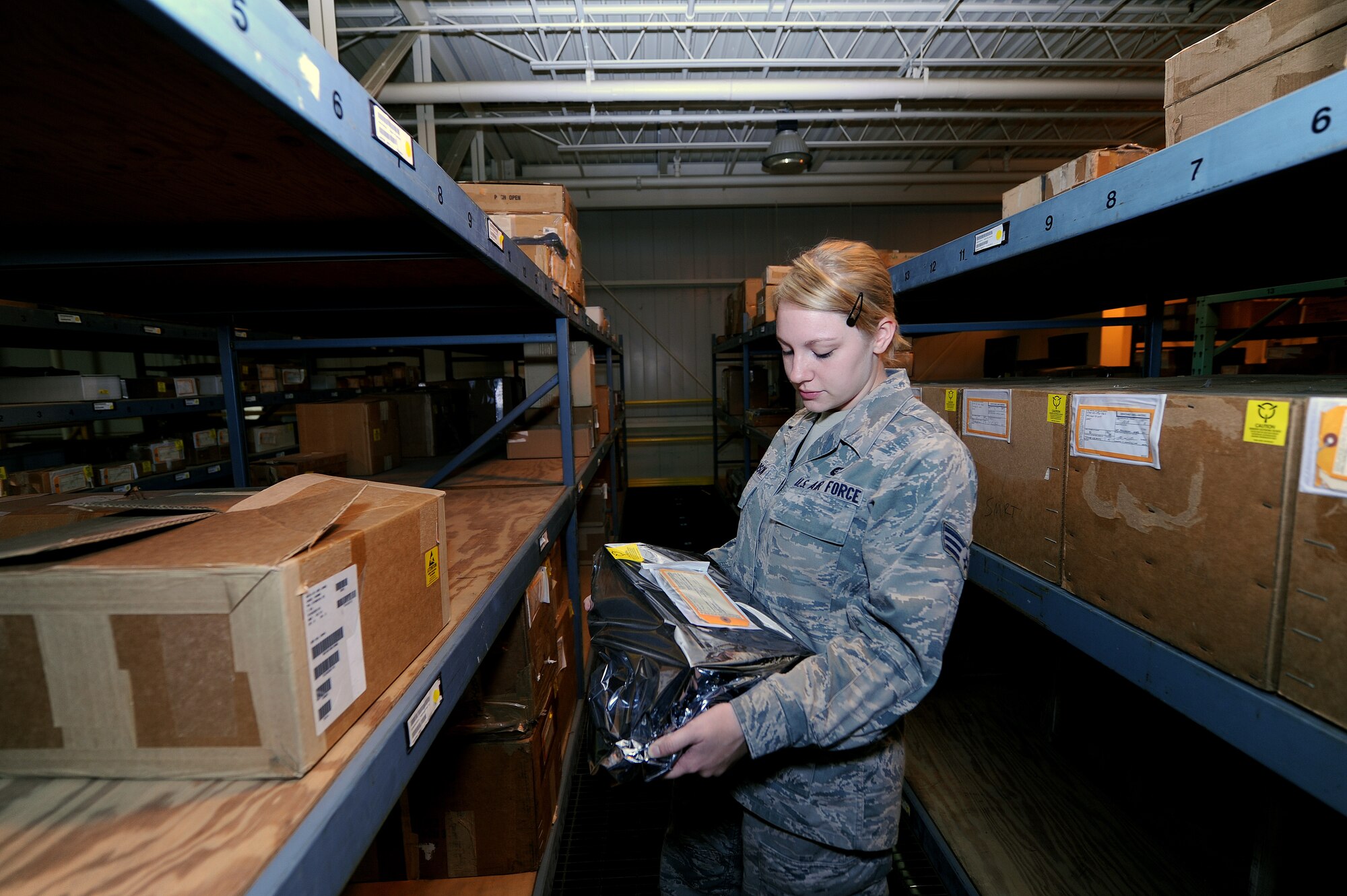 U.S. Air Force Senior Airman Sarah Pearson, 509th Logistics Readiness Squadron aircraft parts journeyman, examines an electrostatic device as part of a routine inspection in the aircraft part store at Whiteman Air Force Base, Mo., Aug. 2, 2013. Electrostatic devices must be packed with specific types of wrapping when they are stowed so the equipment is not damaged during storage. (U.S. Air Force photo by Staff Sgt. Nick Wilson/Released)