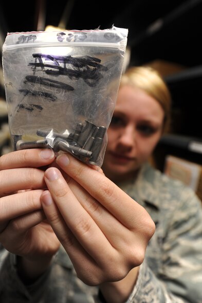 U.S. Air Force Senior Airman Sarah Pearson, 509th Logistics Readiness Squadron aircraft parts journeyman, counts screws in the aircraft part store at Whiteman Air Force Base, Mo., Aug. 2, 2013. Members of the 509th LRS aircraft part store are responsible for providing logistics support to all maintenance units assigned to Whiteman including Guard and Reserve tenant units. (U.S. Air Force photo by Staff Sgt. Nick Wilson/Released) 