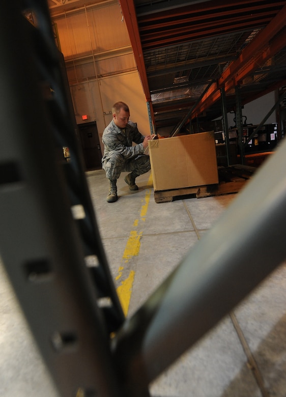 U.S. Air Force Airman 1st Class Christopher Neal, 509th Logistics Readiness Squadron aircraft parts journeyman, places a package in its proper location in the aircraft part store at Whiteman Air Force Base, Mo., Aug. 2, 2013. Along with managing a warehouse filled with equipment, aircraft parts journeymen are responsible for providing equipment to Airmen and civilians who work on the flightline. (U.S. Air Force photo by Staff Sgt. Nick Wilson/Released)
