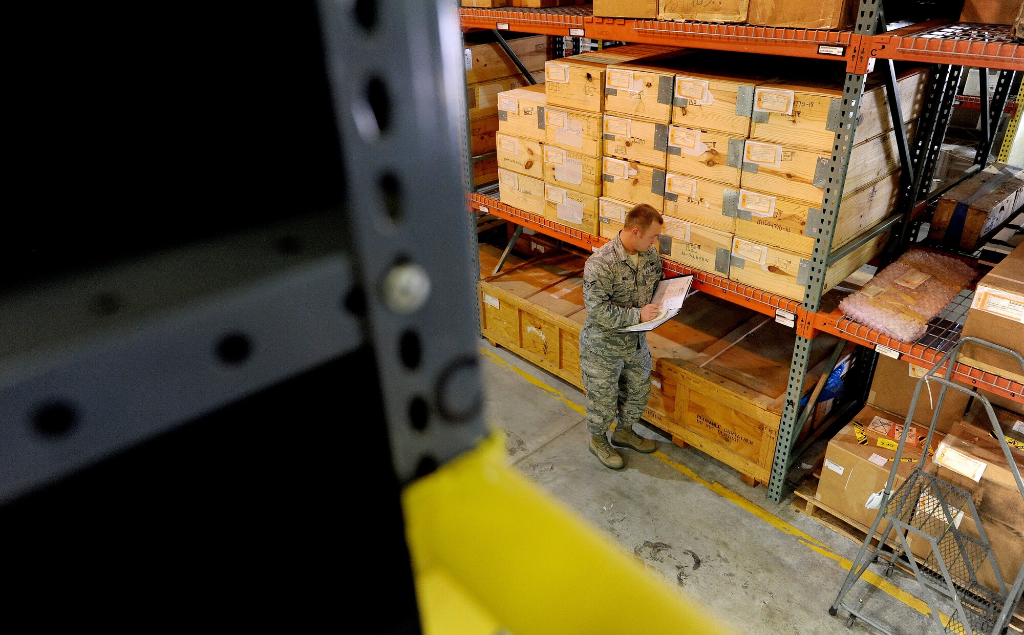 U.S. Air Force Airman 1st Class Christopher Neal, 509th Logistics Readiness Squadron aircraft parts journeyman, annotates the stock number on a piece of equipment during a routine inspection in the aircraft part store at Whiteman Air Force Base, Mo., Aug. 2, 2013. The stock numbers on items help Airmen quantify and maintain accountability of parts stored in the aircraft part store. (U.S. Air Force photo by Staff Sgt. Nick Wilson/Released)