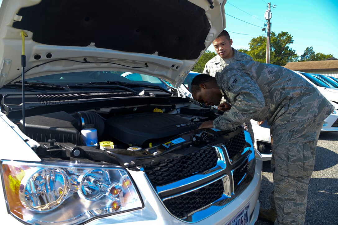 U.S. Air Force Airmen 1st Class Thomas Watkins and Delphia Ith, 633rd Logistics Readiness Squadron vehicle operators, inspect a government vehicle at Langley Air Force Base, Va., Sept. 5, 2013. One of the section’s duties is maintenance of command and control vehicles. (U.S. Air Force photo by Airman 1st Class Victoria H. Taylor/Released)