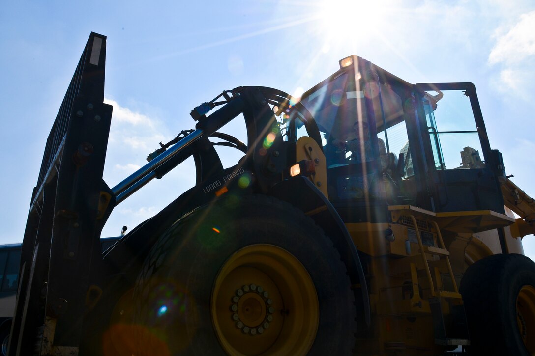 U.S. Air Force Senior Airman James Wilson, 633rd Logistics Readiness Squadron vehicle operator, drives a forklift at Langley Air Force Base, Va., Sept. 5, 2013. Vehicle operators work with many different vehicles, ranging from sedans and buses to utility trucks and tractor trailers. (U.S. Air Force photo by Airman 1st Class Victoria H. Taylor/Released)