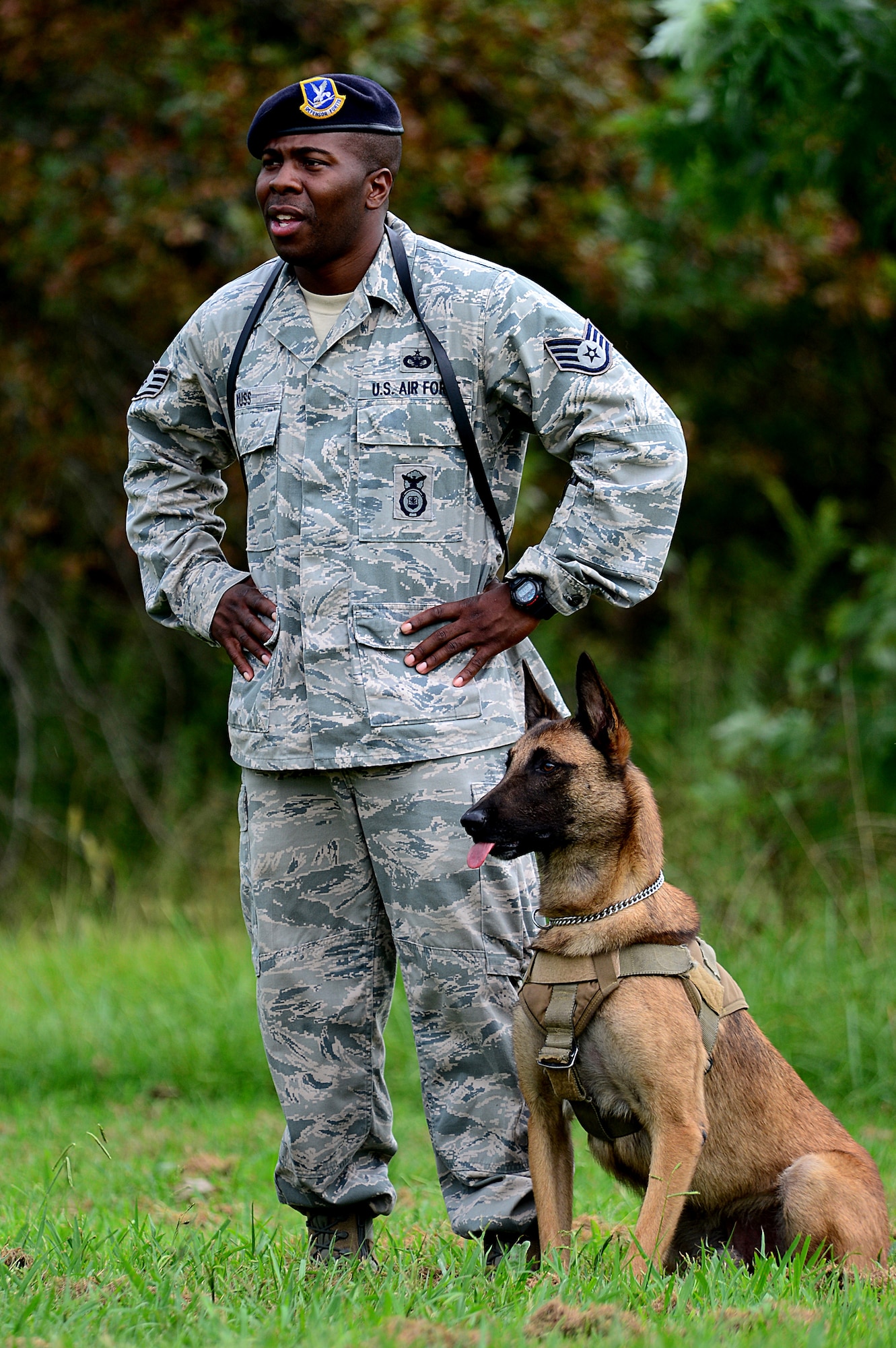 U.S. Air Force Staff Sgt. Dontarie Russ, 633rd Security Forces Squadron military working dog handler, and Uudensi, his partner, prepare for a demonstration at Langley Air Force Base, Va., Sept. 3, 2013. While deployed to Forward Operating Base Masum Ghar, Afghanistan, Russ and Uudensi identified improvised explosive device indicators, as well as actual devices, saving the lives of 43 U.S. Army Soldiers. (U.S. Air Force photo by Senior Airman Kayla Newman/Released)
