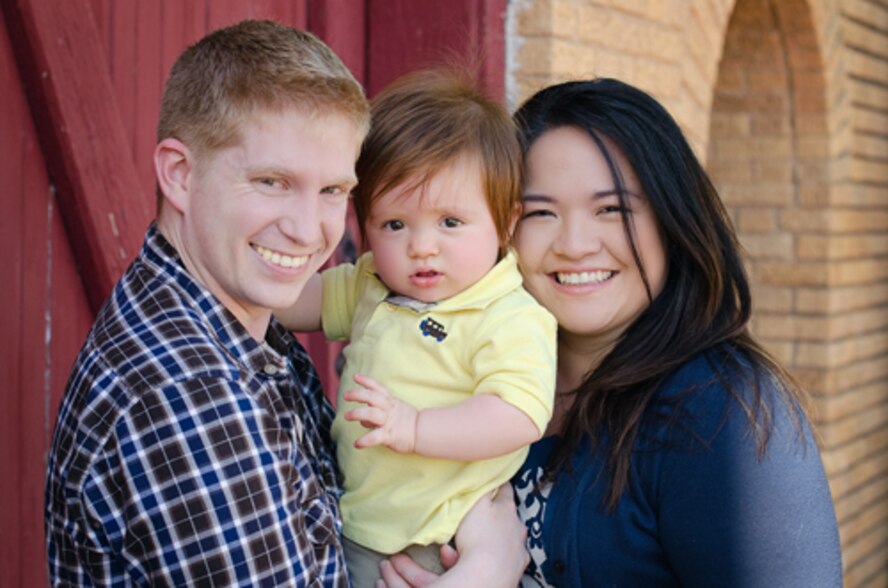 U.S. Air Force Capt. Anthony Rocco, 9th Bomb Squadron, poses for a family portrait with his wife and son. During his first deployment to Southwest Asia in 2012, Rocco served as a pilot on-board Bone-34, which was recently awarded the 2012 Gen. Curtis E. LeMay Outstanding Bomber Aircrew Award. (Courtesy photo)