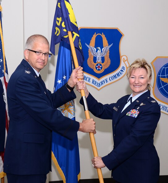 Col. Tim Tarchick, 94th Airlift Wing commander, passes the 94th Aeromedical Staging Squadron flag to Col. Sherry F. Hemby during a Change of Command ceremony at Dobbins Air Reserve Base, Ga., Sept. 8. (U.S. Air Force photo/Brad Fallin)