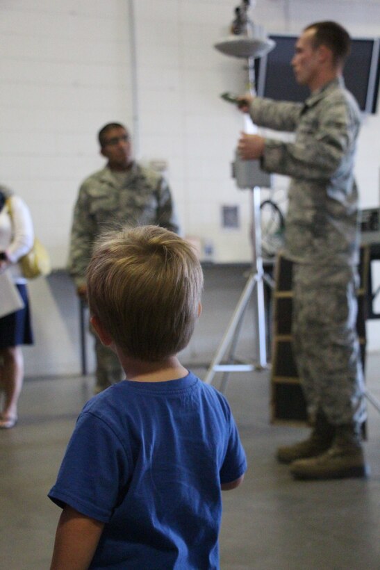 JOINT BASE MCGUIRE-DIX-LAKEHURST, N.J – Freddy Rayner, son of Gibson and Maj. Robert Rayner, director of operations for the 818th Global Mobility Squadron, gets a lesson in solar energy at the 621st Contingency Response Wing’s Global Reach Deployment Center during a Spouse’s Orientation Day Sep. 6, 2013. This event introduced the spouses to one another and provided an inside look at 621 CRW operations. (U.S. Air Force photo by Senior Airman Destinie M. Chavez/released)