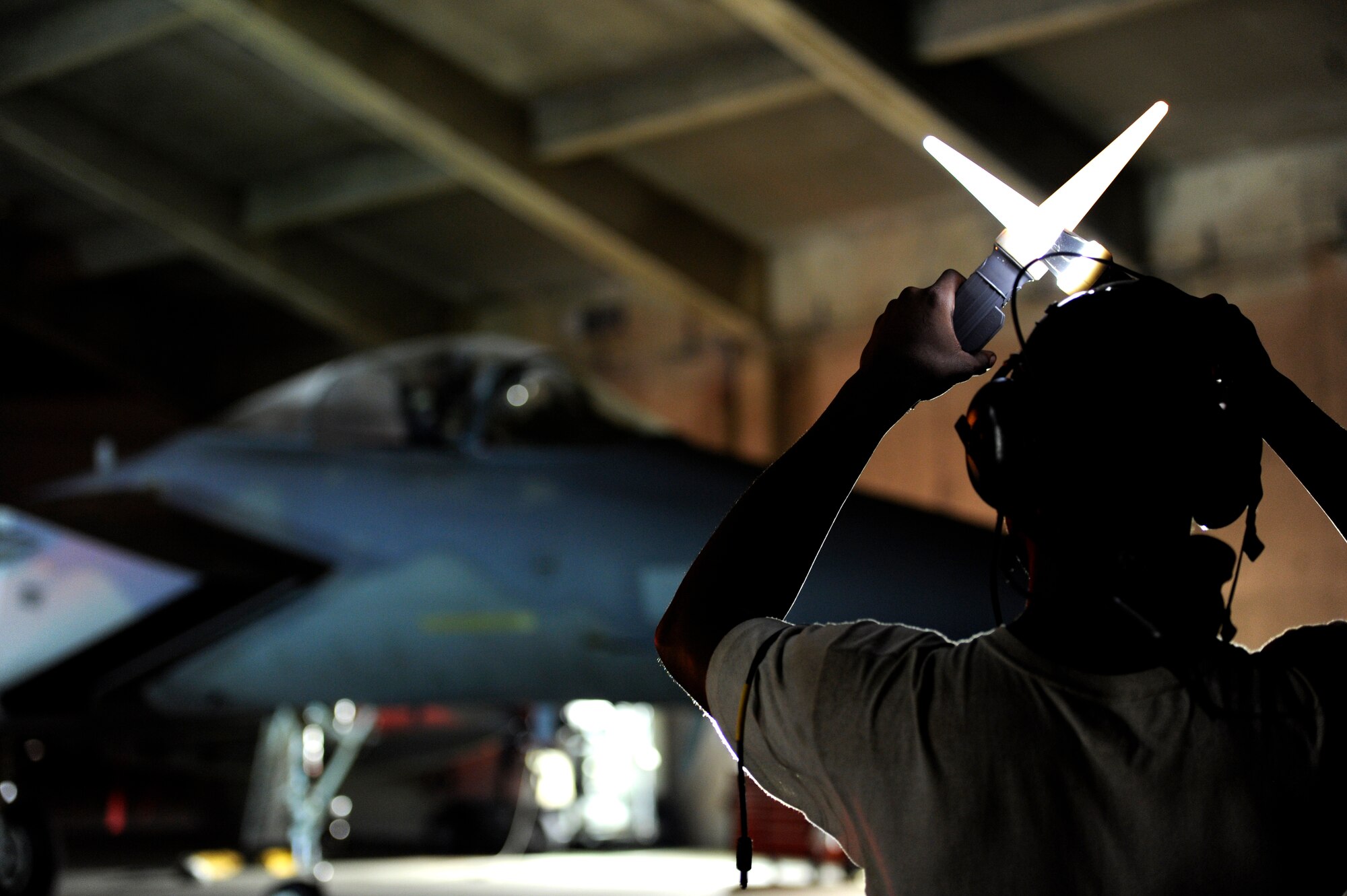 A U.S. Air Force crew chief from the 18th Aircraft Maintenance Squadron prepares to marshal a U.S. Air Force F-15 Eagle onto the flightline during a local operational readiness exercise on Kadena Air Base, Japan, Sept. 9, 2013. The 18th Wing periodically conducts LOREs to maintain proficiency in their capabilities to support the common defense of the Asia-Pacific region. (U.S. Air Force photo by Senior Airman Maeson L. Elleman)