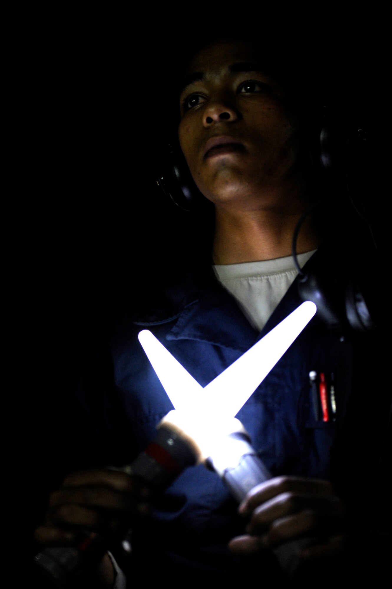 U.S. Air Force Airman 1st Class James A. Fulmer, 18th Aircraft Maintenance Squadron crew chief, prepares to marshal a U.S. Air Force F-15 Eagle onto the flightline during a local operational readiness exercise on Kadena Air Base, Japan, Sept. 9, 2013. The 18th Wing is home to the Air Force's largest combat wing and is the Pacific hub for delivering quick, lethal airpower in support of contingencies and operations in the region. (U.S. Air Force photo by Senior Airman Maeson L. Elleman)