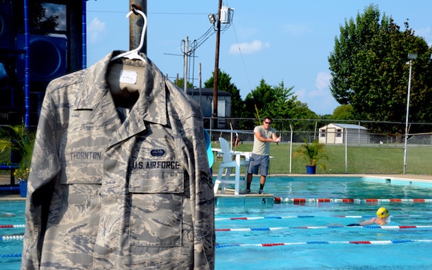 Airman 1st Class Lance Thornton motivates his team swim laps at practice Aug. 30. During Thornton’s first season with the Barracudas, they set 48 personal records out of 56 taper swims. Seven former team members are on current division one college scholarships. In the past three years, the Barracudas have produced an Auburn University swim team captain and four 2012 Olympic trial swimmers.  (U.S. Air Force photo by Airman 1st Class William Blankenship)