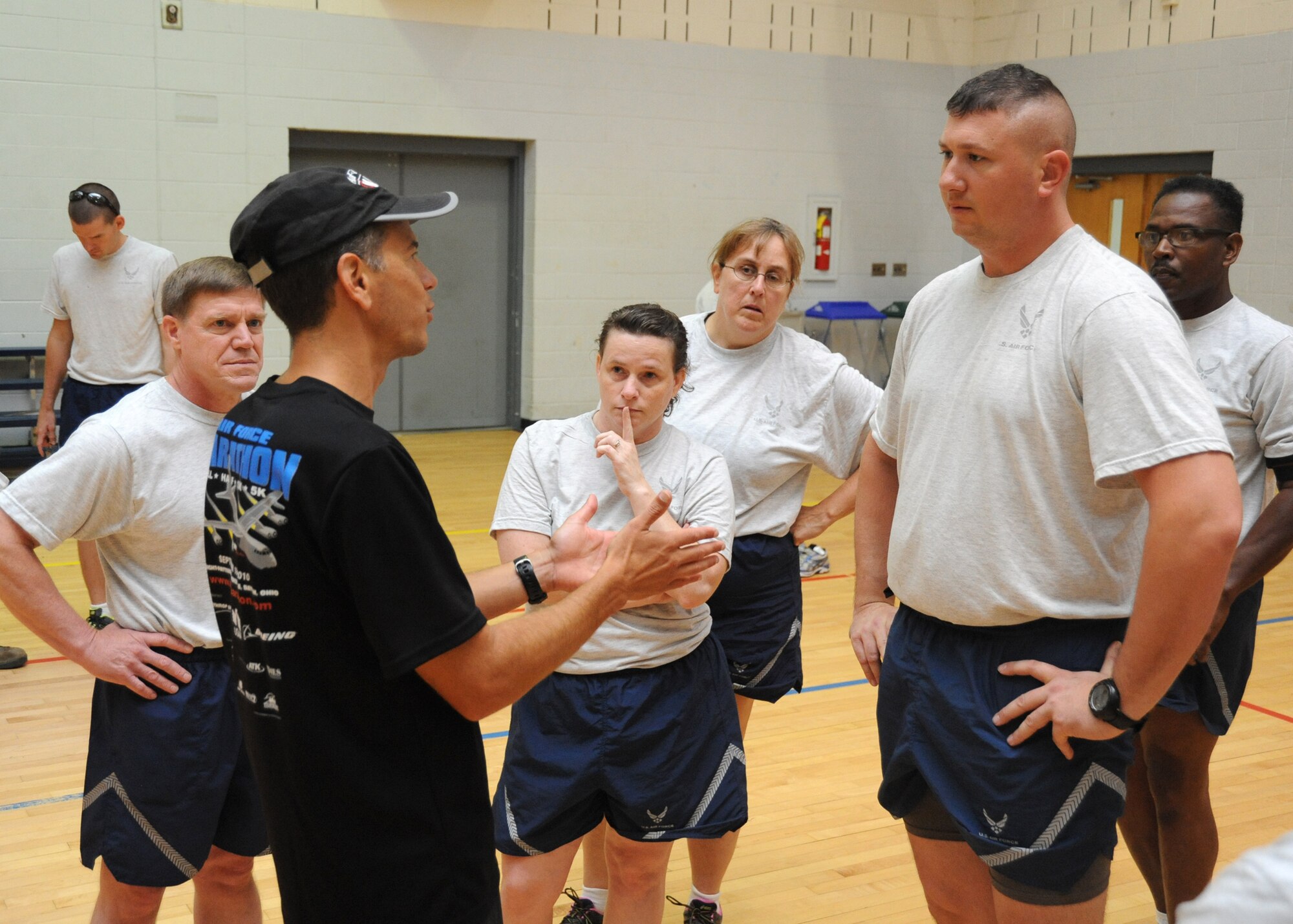 Dr. (Lt. Col.) Antonio Eppolito (left), Chief of Air Force Telehealth, discusses the benefits of Efficient Running with Master Sgt. Jason Bigart, a quality assurance specialist with the 440th Maintenance Group, during an Efficient Running Course in the Hercules Gym at Pope Field, N.C., on Sept. 8, 2013.  Efficient Running transitions runners to a “barefoot-style” of running, where the athlete’s foot impacts the ground with the ball or mid-foot rather than the heel, said Eppolito.  “I knew before this class that I was supposed to run on the balls of my feet, but it’s tough to do in my athletic shoes,” said Bigart, a Milwaukee, Wis., native.  “The class made a lot of sense.”  The 440th Airlift Wing is currently training for worldwide deployment.  (U.S. Air Force photo by Tech. Sgt. Peter R. Miller)
