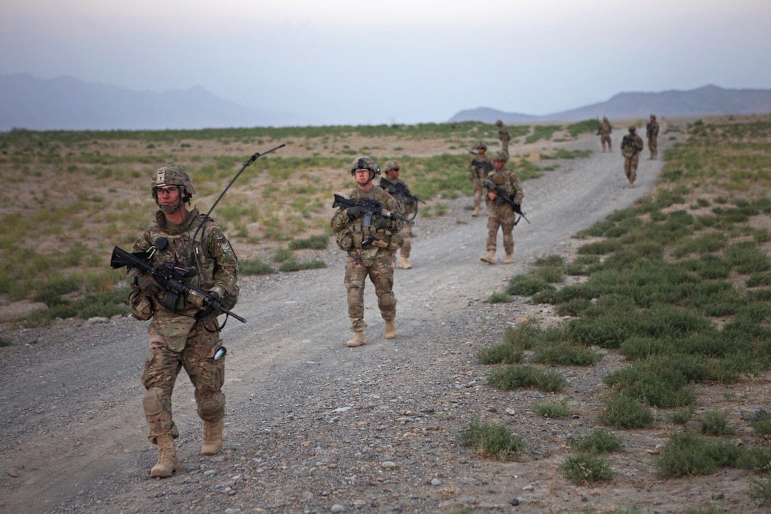 U.S. soldiers patrol along a dirt road in Bagram in Afghanistan's ...