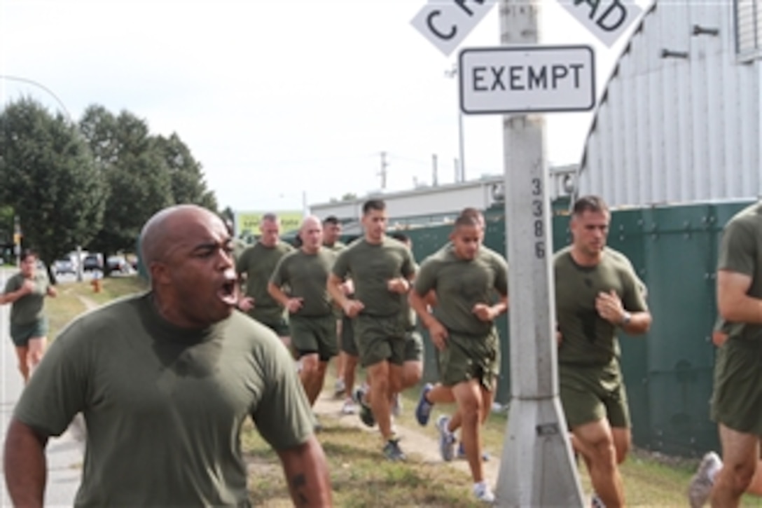 U.S. Marine Corps Gunnery Sgt. Dean A. McCown calls cadence during a formation run in Garden City, N.Y., Sept. 9, 2013. Throughout the run, the Marines took turns calling cadence to help motivate each other and build camaraderie. McCown, a data chief, is assigned to the 1st Marine Corps District.


