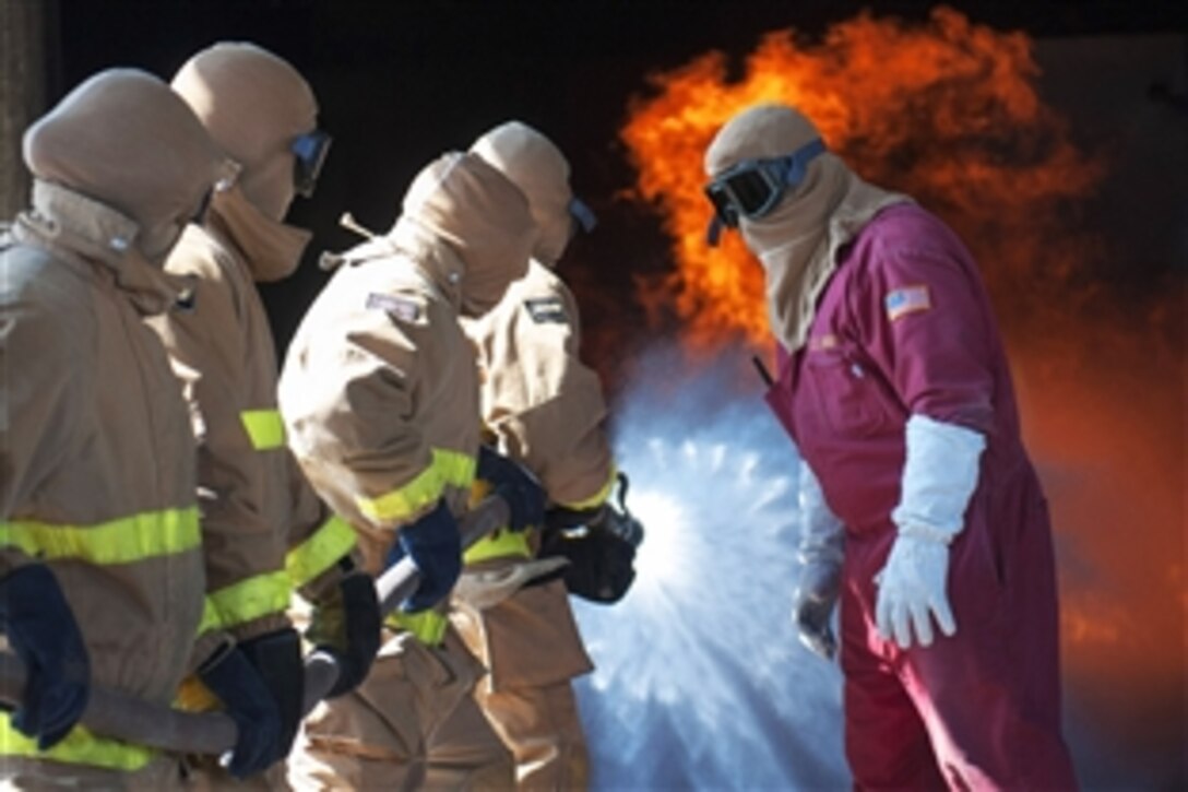 Firefighting instructors give directions to sailors during general shipboard firefighting training on Naval Base San Diego, Sept. 9, 2013. The training consists of classroom courses and hands-on training to teach hose handling, shipboard firefighting and using firefighting equipment.