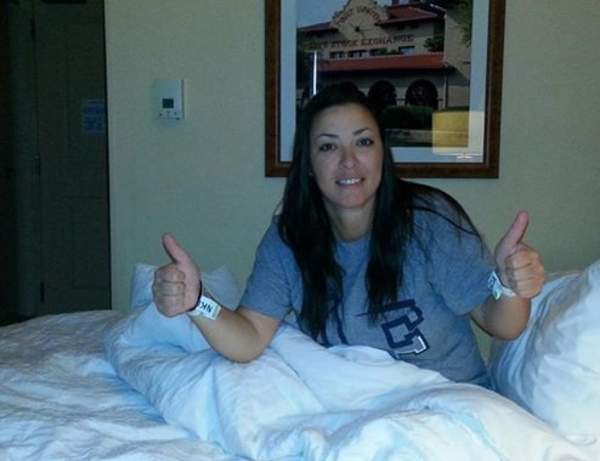 Jacquelyn Polasek gives her family a "thumbs up" from her hotel room Aug. 8, 2013, to show all is well after donating bone marrow at the Cook's Children's Hospital that same day.