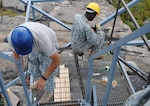 Staff Sgt. Marco Padilla and Spc. Osse Jean-Pierre repair and replace railings on the Mount Beacon fire tower Sept. 7, 2012.