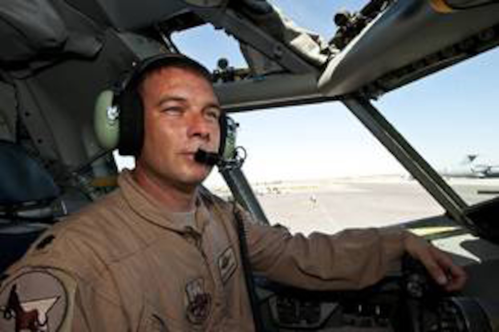 Lt. Col. Aaron Wardlaw gazes out a KC-135 Stratotanker at the Transit Center of Manas, Kyrgyzstan.