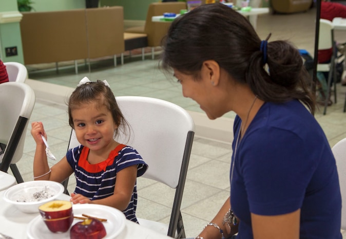 A military child makes a whipped cream spread for her apples during Midway Park Community Center’s Silly Snacks, a weekly program where children make fun, healthy treats, Aug. 23. Healthy food is used regularly at Silly Snacks and seasonal vegetables are a frequent focus.