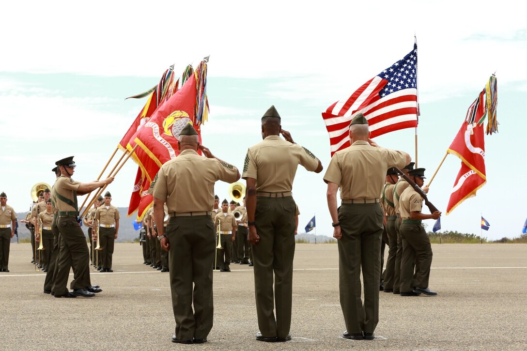 (Right to left) Colonel Jason Bohm, commanding officer, 5th Marine Regiment, Sgt. Maj. Clifford Wiggins, sergeant major, 5th Marines, and Sgt. Maj. Alberto Ruiz, former sergeant major, 5th Marines, salute Marines and sailors as they conduct a pass and review during a relief, appointment and retirement ceremony at the Camp San Mateo helicopter landing pad here, Sept. 6, 2013. Marines and sailors of the Fighting Fifth bid farewell to Ruiz who retired after 30 years of service after relinquishing his post to Wiggins during the ceremony. Wiggins served as the sergeant major of 3rd Assault Amphibian Battalion before assuming his current post. Ruiz is a Laredo, Texas, native, Bohm is an Oyster Bay, N.Y., native, and Wiggins is a Cincinnati native.
