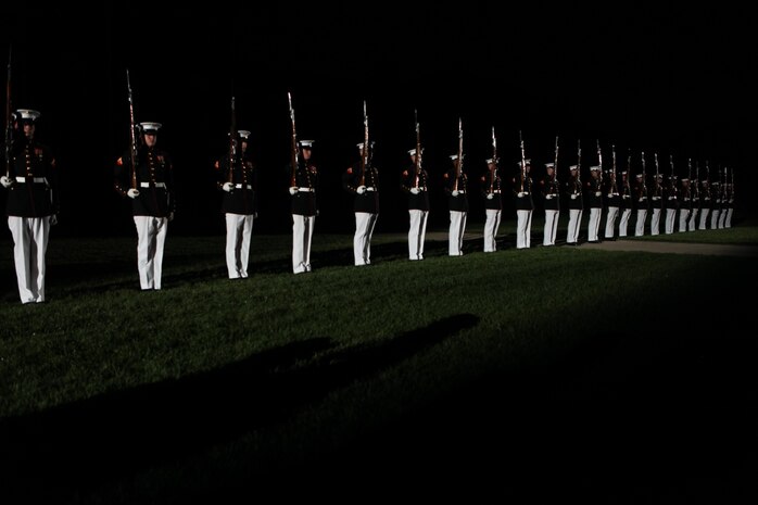 The Marine Corps Silent Drill Platoon stands ready for a drill session during the 8th and I Evening Parade, Aug. 23. With much practice and discipline, the Marines perform drill movements without verbal commands.