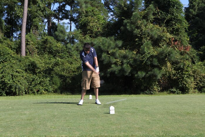 Sgt. Steven J. Carver, Headquarters and Headquarters Squadron training noncommissioned officer, tees off during the CommanderÕs Cup Golf Tournament, Aug. 27.