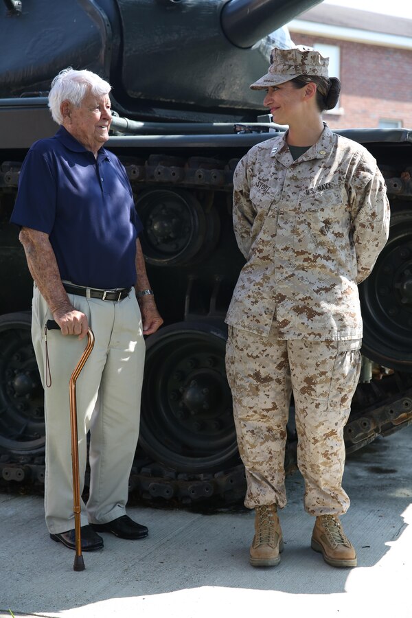Navy Lt. Cmdr. Shannon Stout, the 2nd Tank Battalion medical officer, from Sarasota, Fla., looks at her uncle Neil Stout, a retired Navy petty officer 3rd class and World War II veteran, during her promotion ceremony Sept. 4, 2013 aboard Marine Corps Base Camp Lejeune. Stout became the first female field grade officer in 2nd Tanks history.