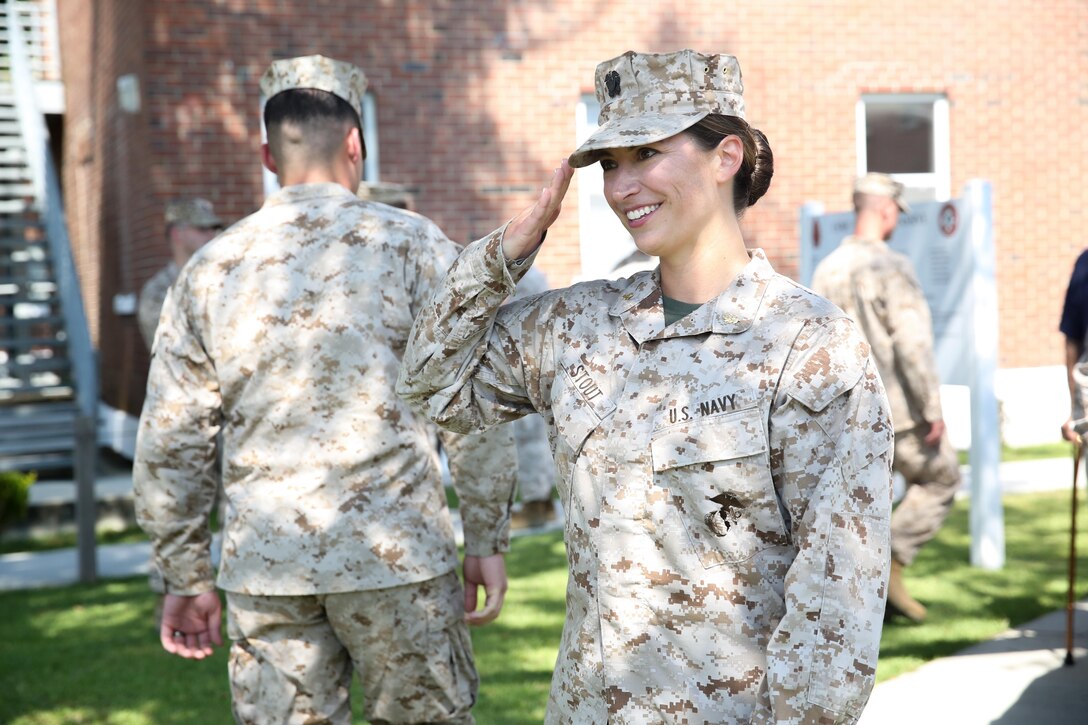 Navy Lt. Cmdr. Shannon Stout, the 2nd Tank Battalion medical officer, from Sarasota, Fla., returns a salute after her promotion ceremony Sept. 4, 2013 aboard Marine Corps Base Camp Lejeune. Stout became the first female field grade officer in 2nd Tanks history.