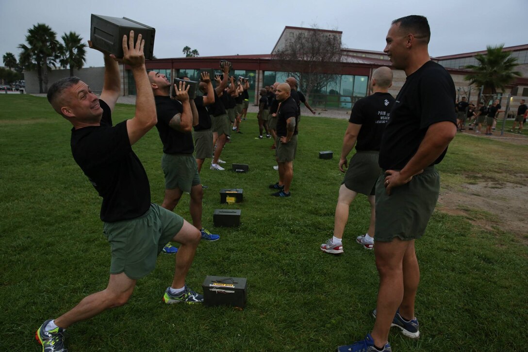 Career Recruiters with the 12th Marine Corps District execute ammo can lifts during high intensity interval training as part of a three-day recruiting seminar at Marine Corps Base Camp Pendleton, Calif., Sept. 10. Career Recruiters attend this seminar to develop professionally and learn methods of leadership. The three days include HITT fitness training, various classes, tactical training and a mess-night. 