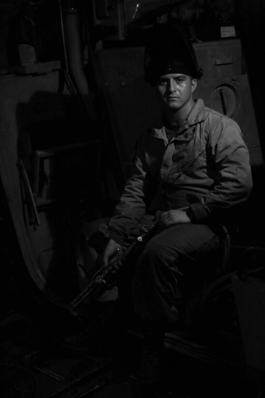 Cpl. Jose I. Navarrette a metal worker with Maintenance Detachment, Combat Logistics Battalion 13, 13th Marine Expeditionary Unit, works out of an amphibious assault vehicle-R7, with other members of his maintenance crew while on ship or in the field during their 2013 Western Pacific Deployment. Marines and Sailors with 13th MEU will deploy for several months in support of theater requirements of Geographic Combatant Commanders. (Official U.S. Marine Corps photo illustration by Sgt. Christopher O'Quin/Released)