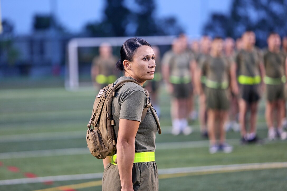 Gunnery Sgt. Joanna H. Mendoza, Headquarters Company gunnery sergeant, Combat Logistics Regiment 17, 1st Marine Logistics Group, calls the Marines to attention to conduct physical training held in memory of the heroes of 9/11 aboard Camp Pendleton, Calif., Sept. 11, 2013. The Marines performed circuit exercises over a 20-minute period and concluded with speeches by various staff members to remember those who have fought and served to protect the country. 