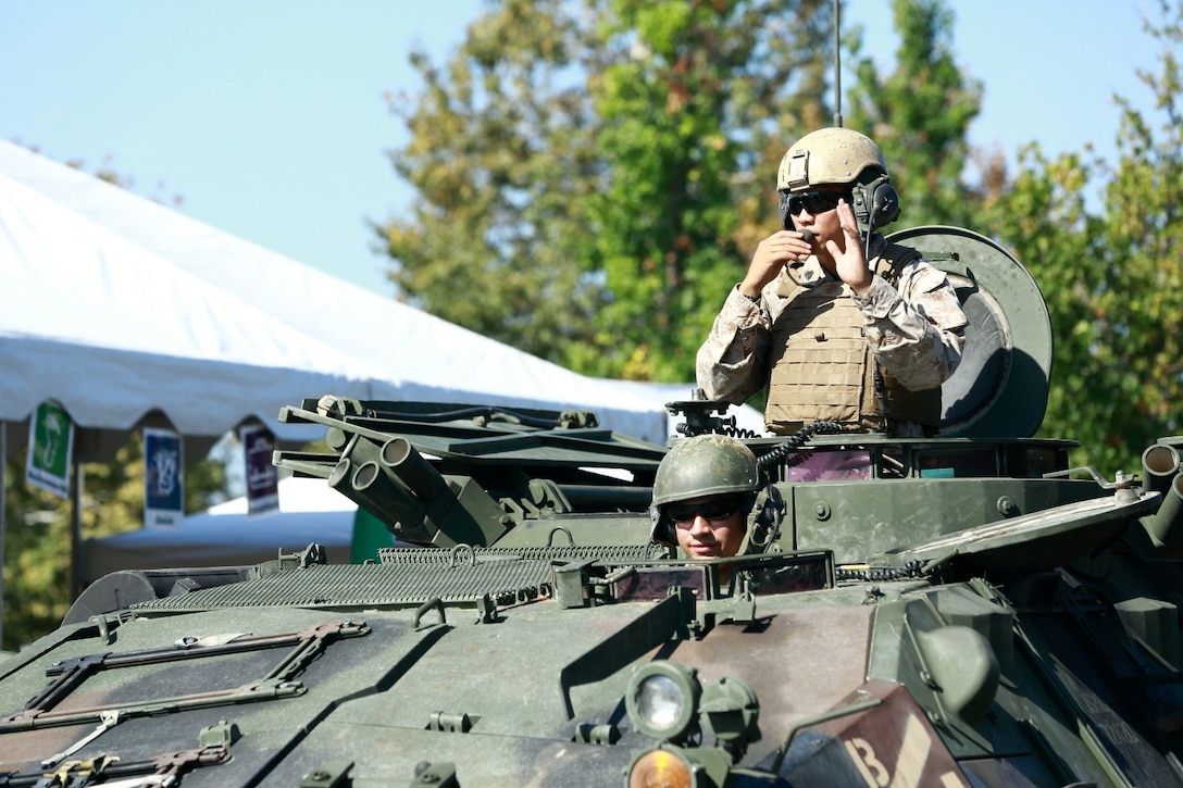 Marines serving with 1st Light Armored Reconnaissance Battalion ride their light armored vehicle variants during the Poway Days Parade here, Sept. 7, 2013. The parade is a 48-year civic tradition that celebrates the town's western heritage. The parade included about 100 sections and 40 participating organizations. More than 50 volunteers with the Highlander Battalion participated in different events throughout the day, including a 5k race and free breakfast service, in order to support the community.