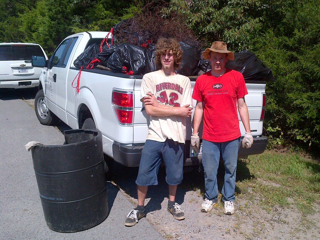 Two volunteers haul trash collected Sept. 7, 2013 from the Hurricane Creek Launching Area at J. Percy Priest Lake in La Vergne, Tenn.