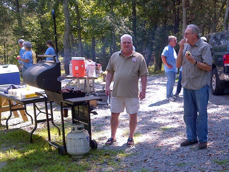 Volunteers from Bridgestone take time out Sept. 7, 2013 to enjoy a hot dog and lemonade after the cleanup at Anderson Road Campground in Nashville, Tenn.