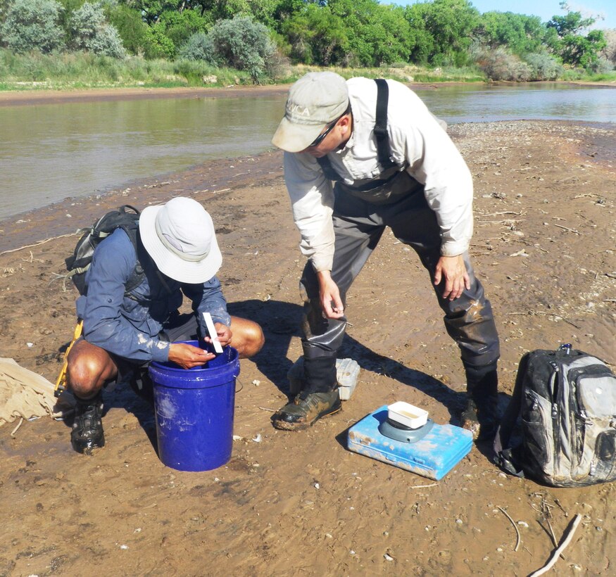 ALBUQUERQUE, N.M., -- Justin Reale (left) and Eric Gonzalez analyze a fish, Aug. 15, 2013.