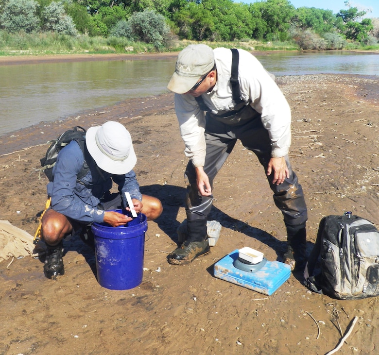 ALBUQUERQUE, N.M., -- Justin Reale (left) and Eric Gonzalez analyze a fish, Aug. 15, 2013.
