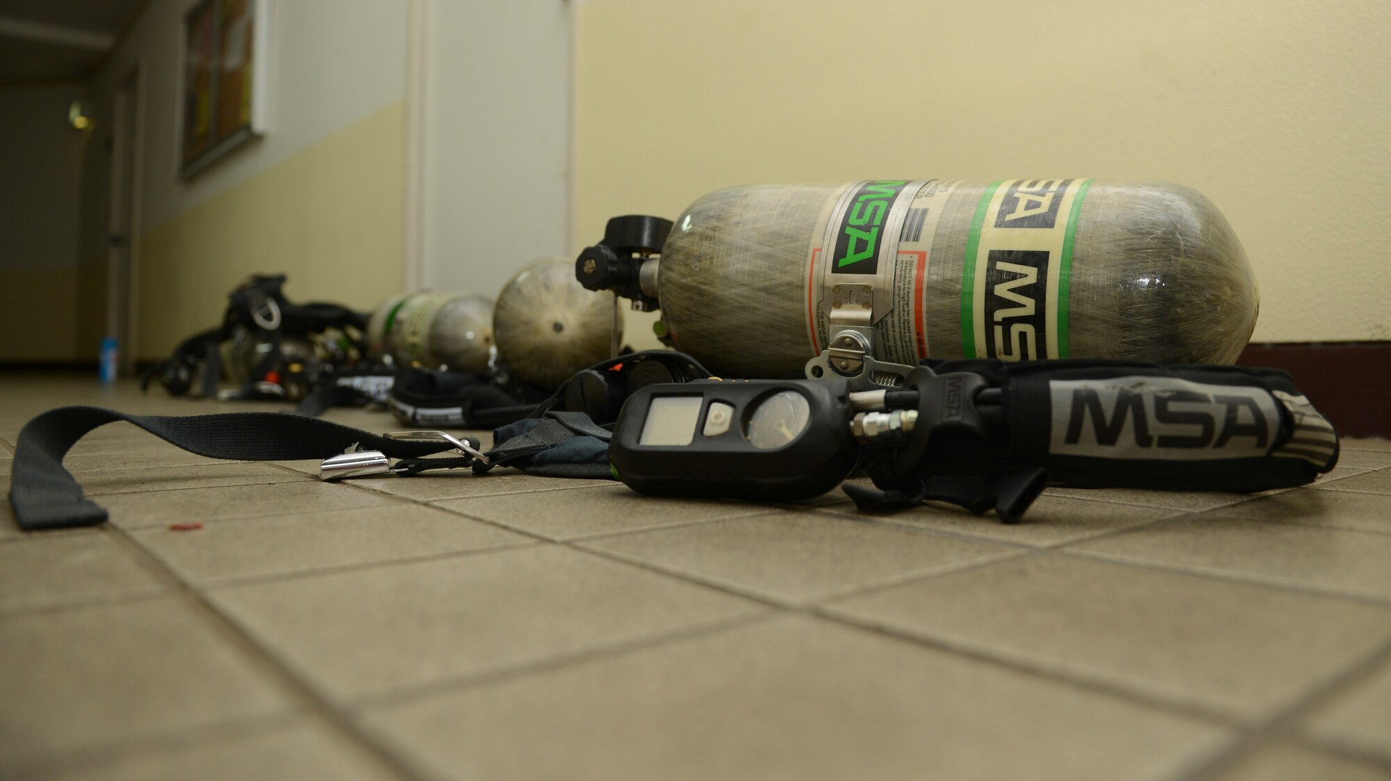 Four sets of self contained breathing apparatus’ lay on the floor of building 1561 during the Remember the Fallen tower run at Yokota Air Base, Japan, Sept. 11, 2013. Each of the tanks weighs roughly 35 pounds. Nineteen teams competed in the challenge with the 374th Medical Group having the fastest time. In total, each team climbed a total of 110 floors, simulating the height of the Twin Towers. (U.S. Air Force photo by Senior Airman Michael Washburn/Released)