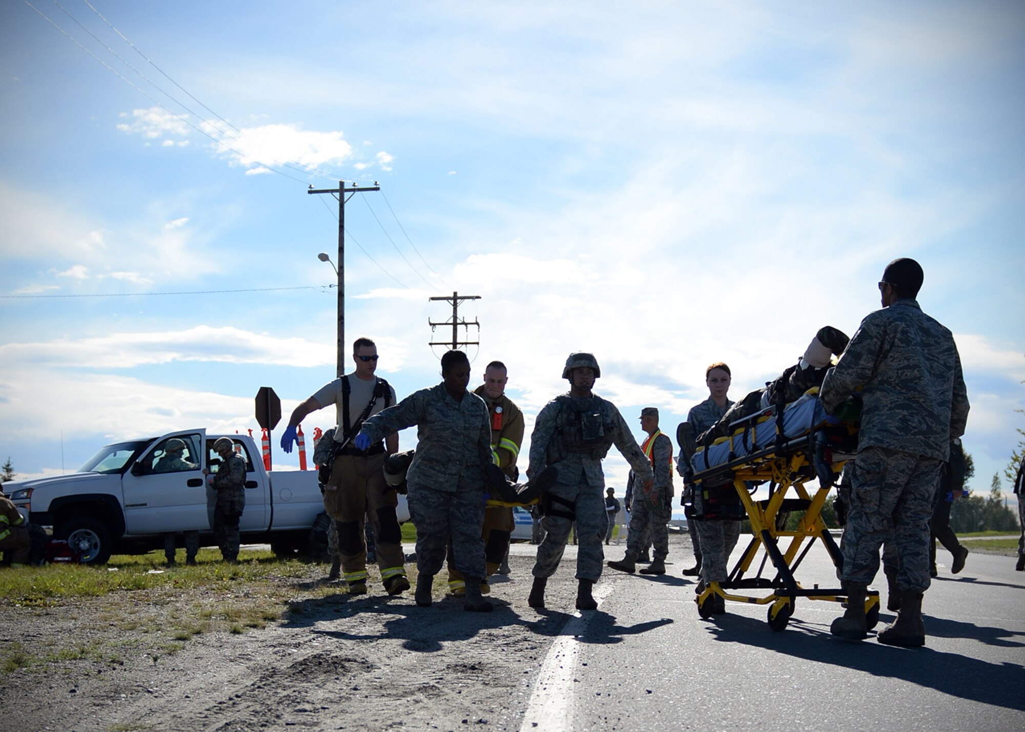 Emergency responders transport simulated victims during an active shooter exercise Sept. 10, 2013, Eielson Air Force Base, Alaska. Several base agencies responded to the scenario which is part of the Pacific Air Forces Readiness Focused Consolidated Unit Inspection to evaluate the base on readiness and compliance with operational instructions. (U.S. Air Force photo by Senior Airman Shawn Nickel/Released)
