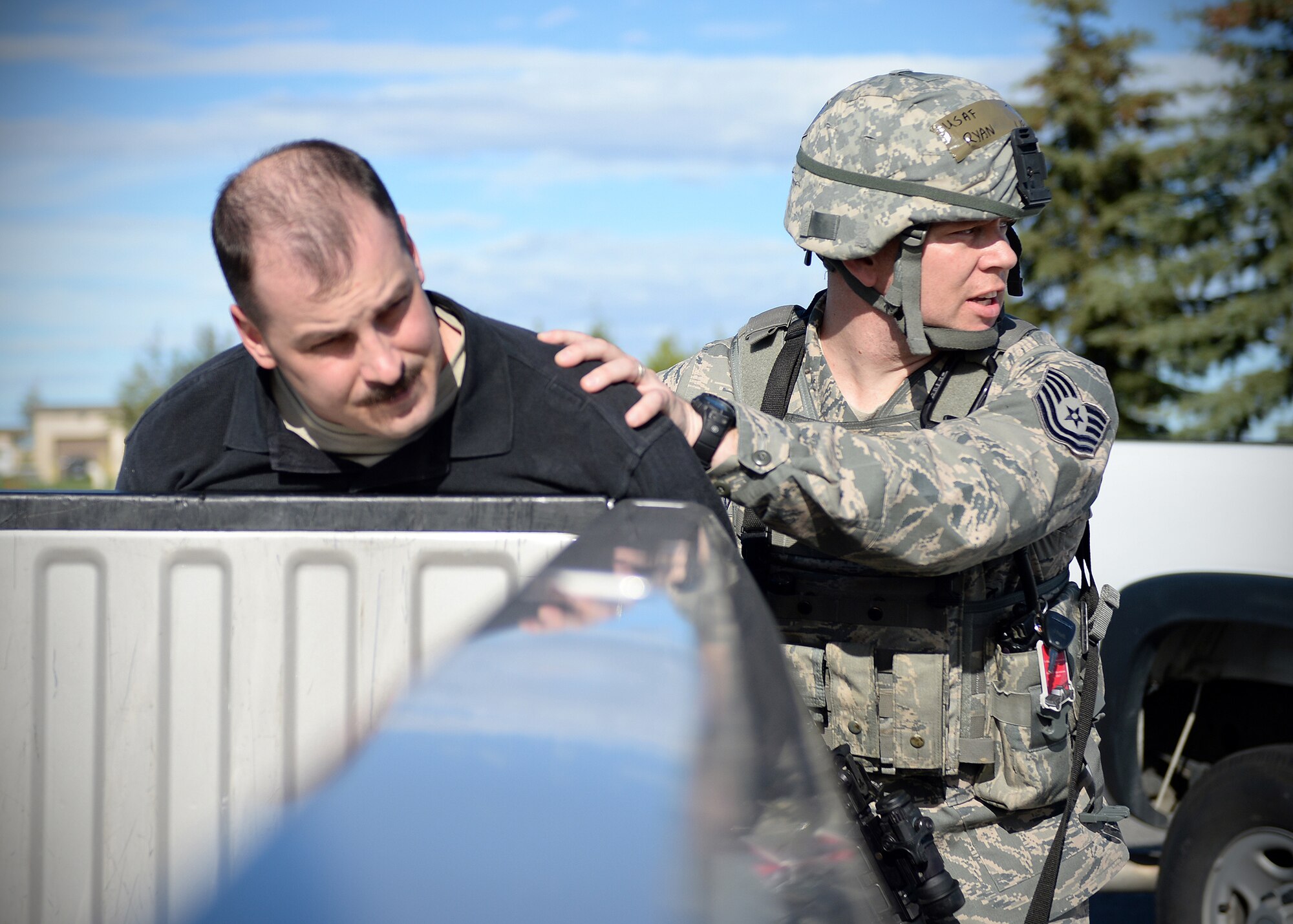 Tech. Sgt. Ryan Overcash, 354th Security Forces Squadron flight sergeant, transports a simulated active shooter suspect during an exercise Sept. 10, 2013, Eielson Air Force Base, Alaska. Emergency responders quickly apprehended the suspect during an exercise scenario, which is part of the Pacific Air Forces Readiness Focused Consolidated Unit Inspection to evaluate the base on readiness and compliance with operational instructions. (U.S. Air Force photo by Senior Airman Shawn Nickel/Released)